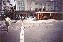 Surprise! A Riverfront streetcar is seen running along new Canal Streetcar trackage; it discharges some passengers at Canal & Bourbon Streets
