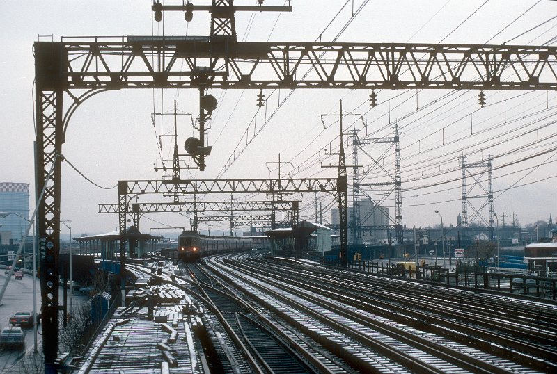 19820551-cr-cdot.jpg - Westbound ConnDOT/Conrail commuter train (8539/38-8745/44-8707/06) passing the former Bridgeport train station. The line to Trumbull and Newtown branched off to the left. December 23, 1982.